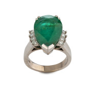 An 18ct white gold dress ring set with spectacular pear shaped emerald apprxoimately 11ct, flanked by eight brilliant cut diamonds on the shoulders, 13.4 grams,