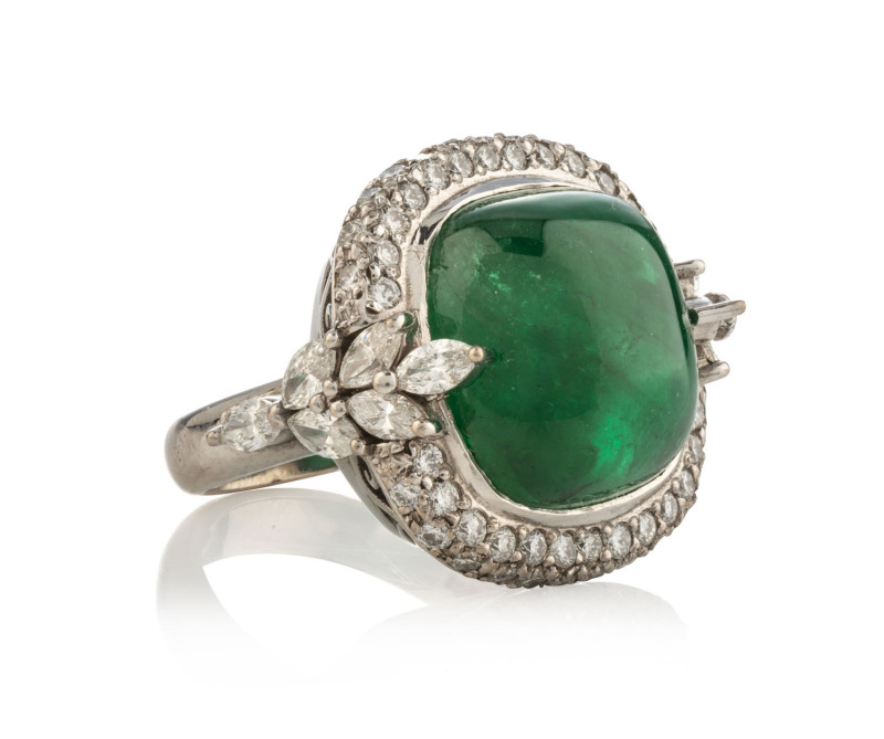 An 18ct white gold ring with 13.5ct cabochon emerald surrounded by 2.5 carats of brilliant cut diamonds, 16.9 grams, [Diamond & Gemstone Bourse (Aust.) insurance valuation $15,950]