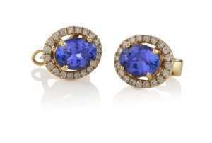 A pair of 14ct yellow gold cluster designed earrings set with oval tanzanites surrounded by brilliant cut diamonds