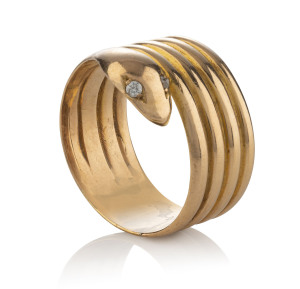 An 18ct rose gold coiled serpent dress ring with rose cut diamond eyes, with pictorial hallmarks inside the shank, weight 12.3 grams total