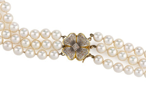 A TRIPLE STRAND PEARL CHOKER With yellow gold and diamond floral clasp, length 38cm