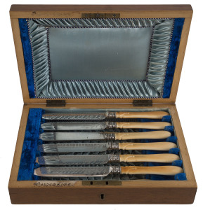 An English fish cutlery set in walnut box, silver plate with ivory handles and silver collars, 19th century