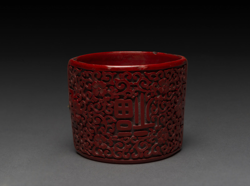 A Chinese cinnabar lacquer bracelet, 19th century, ​6cm wide
