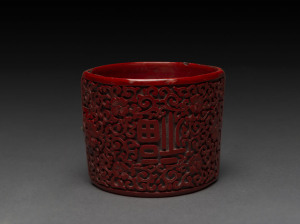 A Chinese cinnabar lacquer bracelet, 19th century, 6cm wide