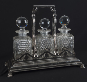 An English silver plated three bottle tantalus by Walker & Hall with diamond registration mark, 19th century, 30cm high