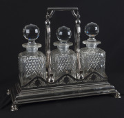 An English silver plated three bottle tantalus by Walker & Hall with diamond registration mark, 19th century, ​30cm high