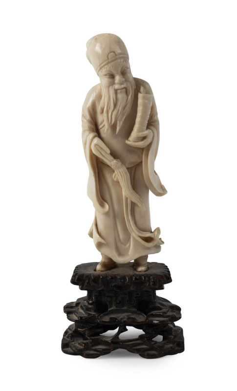 A Chinese carved ivory statue of a scholar on original wooden stand, 19th century, ​14cm overall