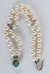 A cultured pearl bracelet, two rows of round pearls 6.8-7.1mm with 9ct yellow gold clasp set with opal doublet, 20cm long