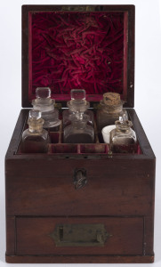 An antique mahogany apothicary box with red velvet compatment interior with assorted bottles, accompanied with a hand written note "This was a medical chest belonging to the late Father J.P. LYNCH who came to Australia from Ireland in the 1890's and who served in the BALLARAT diocease". 20cm high, 17.5cm wide, 17.5cm deep