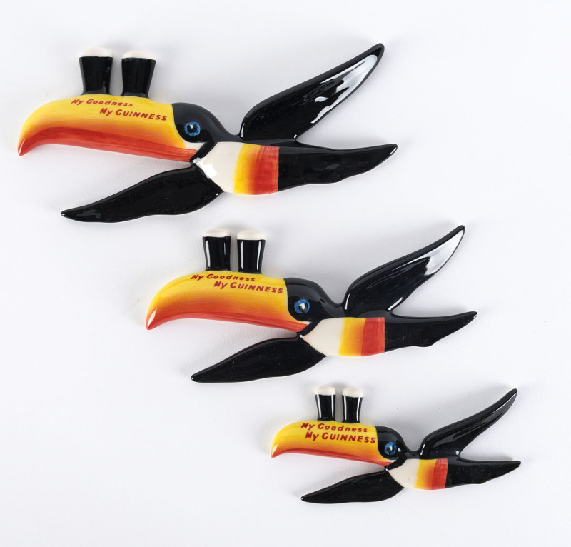 Set of three Guinness flying toucan wall plaques, late 20th century, stamped with the Carlton Ware factory mark, ​the largest 26cm long