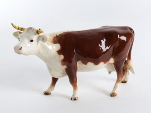 BESWICK WARE Porcelain hereford cow, mid 20th century, stamped "Beswick, England", 13cm high, 22cm long