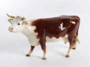 BESWICK WARE Porcelain hereford cow, mid 20th century, stamped "Beswick, England", 13cm high, 22cm long