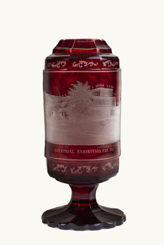 A Bohemian ruby overlay glass vase with a view of The Crystal Palace in London, inscribed "The Industrial Exhibition For 1851", ​21cm high