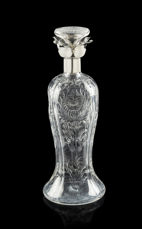 An exceptional Stevens & Williams whisky decanter, intaglio cut rock crystal with sterling silver collar, Birmingham, circa 1913, 30.5cm high