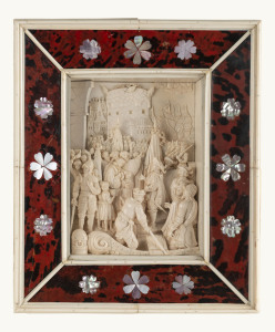 A superb German carved ivory panel depicting a medieval triumphant return with thronging crowds amidst a castle backdrop and harbour scene, housed within a fine tortiseshell frame inlaid with florets of mother of pearl and bound again in ivory with leathe