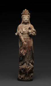 An 18th century Chinese carved wood and polychromed figure of Guan Yin adorned with an elaborate headress and standing on a rocky outcrop, later wooden plinth mounted for a lamp added in the early 20th century, 85.5cm high, PROVENANCE: Christie's, Melbourne, 31th March 2004, lot 98.