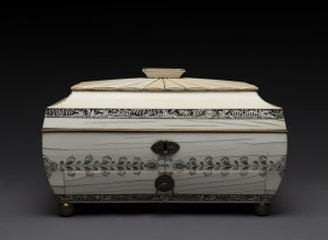 An Anglo-Indian vizagapatam ivory workbox of sarcophagus form, with gadrooned cover and bands of leaves, birds and figures, interior beautifully fitted with sandlewood and ivory compartments, early 19th century, 19cm high, 31cm wide, 22cm deep