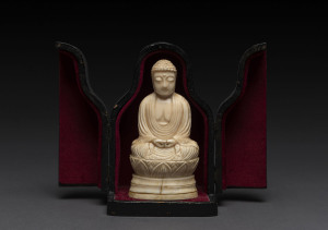 A Japanese carved ivory okimono seated Buddha, Edo Period, early 19th century, housed in a plush lined travel case, 11cm high. PROVENANCE : Shapiro Auctions, Estate of a Gentleman, September 23rd, 2008.