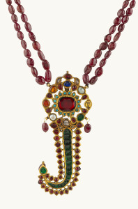 Antique Royal head-pin for a man, 22ct gold and precious stones including rubies, emerald, diamonds, sapphires, pearls and turquoise; now suspended on a red stone necklace, 19th century 11cm high, 96 grams total