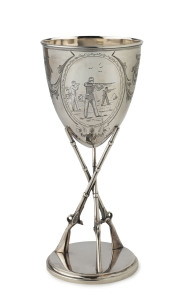An attractive sterling silver rifle shooting trophy, Sheffield 1882, with a cup mounted above three upright rifles standing on a base. One panel engraved with a military shooting scene; another cartouche vacant. 19.5cm tall. 240gms.
