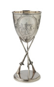 An attractive sterling silver rifle shooting trophy, Sheffield 1882, with a cup mounted above three upright rifles standing on a base. One panel engraved with a military shooting scene; another cartouche vacant. 19.5cm tall. 240gms.