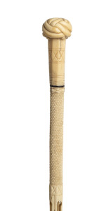 A whalebone walking stick with whale tooth Turkmans knot handle inlaid with tortoiseshell and baleen, 19th century, 85cm high