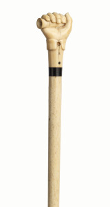 A whalebone walking stick with whale tooth handle in the form of a fist and lignum vitae spacer, 19th century, 89cm high