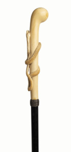 A fine walking stick with long ivory handle adorned with a carved snake, ebony shaft, ivory ferrule and woven silver collar, 19th century, 91cm high