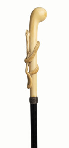 A fine walking stick with long ivory handle adorned with a carved snake, ebony shaft, ivory ferrule and woven silver collar, 19th century, ​91cm high