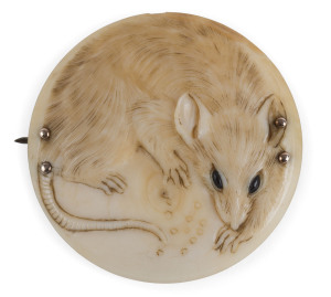 A Japanese rat brooch, finely carved ivory and rose gold, Meiji Period, 19th century, ​4cm diameter