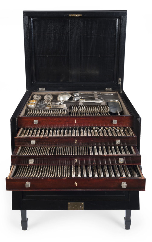 An English sterling silver cutlery set originally for 18 people with servers and accessories. ​By Frederick Elkington of London, circa 1888, housed in a four tier canteen cabinet with ebonized finish. Missing one spoon and one knife blade. 12kg plus of s