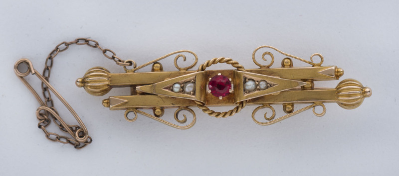 A yellow gold bar brooch set with red stone and seed pearls by T. WILLIS & SONS, Melbourne