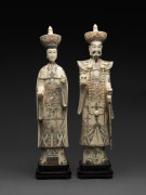 A pair of ancestral figures, carved and painted bone, 20th century, ​51cm overall