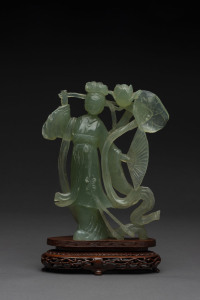 A Chinese green jade carved Guan Ying statue on wooden stand, 20th century, ​25cm overall