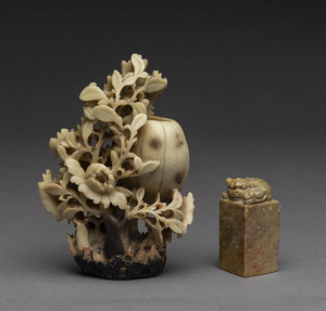 A Chinese carved soap stone figure and seal, 20th century, 14cm and 6cm high