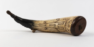 A powder horn with engraved design and cedar fittings, 19th century, 35cm long
