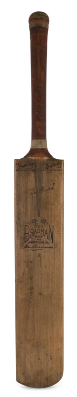 A RECENTLY DISCOVERED BRADMAN BAT FROM THE BODYLINE SERIES A "DON BRADMAN N.S.W. and AUSTRALIAN XI WORLD'S RECORD" full-size cricket bat by SYKES; signed "Don Bradman" in the ownership position and on the left size of the rear of the blade by sixteen memb