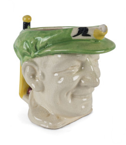 DON BRADMAN toby jug, with cap in green, made by Marutomo Ware, 1934, 15cm high.