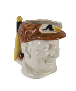 DON BRADMAN, small toby jug with cap in brown, 10cm high, made by Marutomo Ware, 1934.