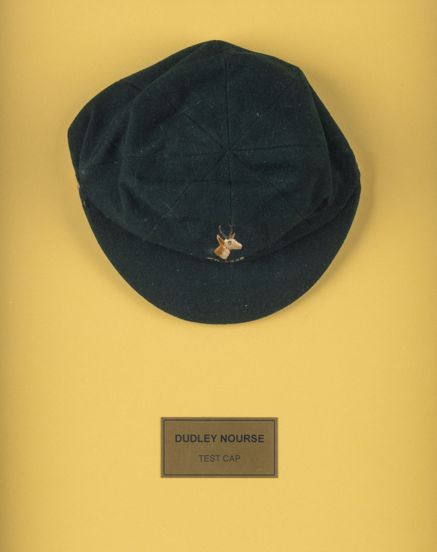 DUDLEY NOURSE’S SOUTH AFRICA 1935 TEST TEAM CAP, green wool, embroidered springbok & 'S.A.1935' on front, made by Devereux of Eton, and named to NOURSE in pen on the label. Good match-worn condition. Attractively framed.