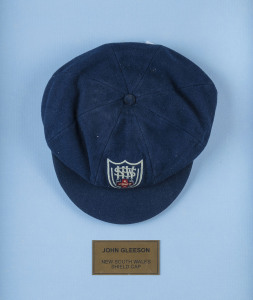 JOHN GLEESON'S NEW SOUTH WALES STATE TEAM CAP blue wool, embroidered 'NSWCA' shield logo on front. Attractively framed. [Gleeson played in 29 Tests for Australia between 1967 and 1972; he was first selected for the NSW Team in 1966. He was best known for 