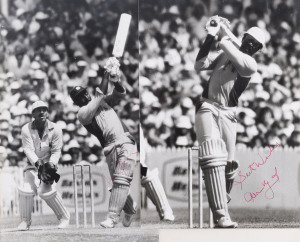 VIV RICHARDS & CLIVE LLOYD autographed, black & white action photographs (2) of the great West Indies batsmen in their follow-through positions; Rod Marsh looks frustrated behind Richards' wicket. Both approx 28 x 20cm.