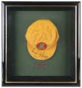 RODNEY HOGG'S REBEL TOUR TEST TEAM CAP, yellow wool with the logo to front (Kangaroo & Springbok on a red cricket ball), signed to the peak by Rodney Hogg. Attractively framed. [Hogg represented Australia in 38 Test matches between 1978 and 1984]. - 2