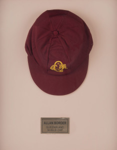 ALLAN BORDER'S QUEENSLAND CRICKET CAP, deep red, embroidered yellow "QCA" monogram on front, "Albion" label inside endorsed "AB" & signed "Allan Border". Fine condition. Attractively framed. [Border represented Queensland in 98 matches between 1980 and 19