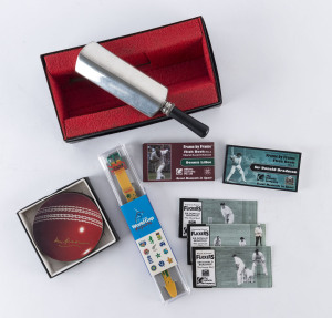 Cricket Miscellany, comprising a Sheffield Mint whisky flask in the shape of a cricket bat; a set of 4 drinks coasters in the shape of cricket balls sihned by Don Bradman; a World Cup England 1999 commemorative watch in box of issue plus 5 modern flicker books (4 of Bradman, 1 of Lillee). (11 items).