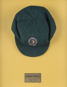 HANSIE CRONJE'S MATCH WORN SOUTH AFRICAN TEST TEAM CAP 1993/94, with U.C.B. South Africa ball and wicket logo on front and "Sacop Brand" label signed in ink "HANSIE CRONJE". Attractively framed.