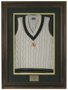 MARK WAUGH'S Australian Test jumper (sleeveless) from the 1996-97 Test Series, with embroidered Australian coat-of-arms on front. Signed to the label and attractively framed and glazed; overall 114 x 84cm. - 2