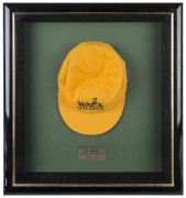 JO ANGEL'S WESTERN AUSTRALIA CAP, yellow wool with the WACA logo embroidered to front and signed beneath the peak by Jo Angel. Attractively framed.A giant fast bowler standing 6 feet 6 inches (198 cm) tall, Angel took 485 first-class wickets, including 44 - 2