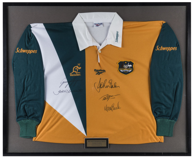 Australian Rugby Union 1997 Bledisloe Cup Wallabies guernsey signed by JOHN EALES (Aust. Captain), GEORGE GREGAN, TIM HORAN and MATTHEW BURKE, framed & glazed, 79 x 94cm overall. 