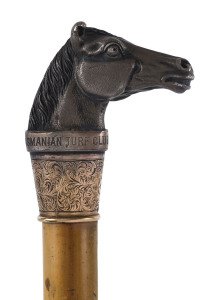 HORSE RACING IN TASMANIA: A RIDING CROP, topped with horse's head, engraved "Tasmanian Turf Club 1879", and with a 9ct gold collar engraved "Ladies Cup, Won By Swiveller, Wm Martin, 13st 12lbs".Swiveller had also won the Hobart Cup in 1878 and the Launceston Cup in 1879 and 1880.
